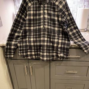 This is a pull over north face jacket plaid half a zip with a hoodie